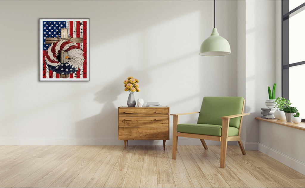 Diamond painting of an eagle, cross, and American flag wreath hanging on a wall above a wooden cabinet.