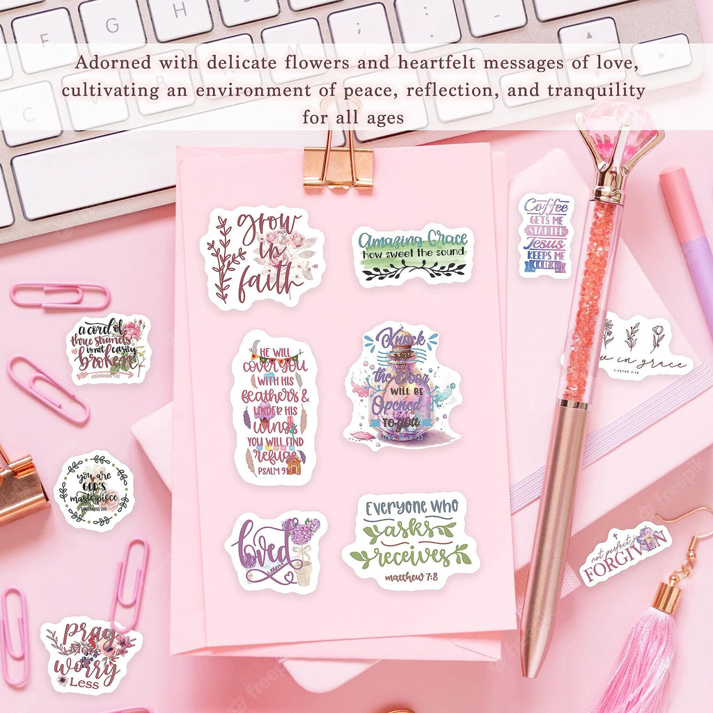 Collection of inspirational Christian stickers with floral designs and Bible verses, arranged on a pink surface with office supplies.