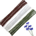 Three bundles of floral wire in brown, white, and green, with a small cluster of blue cornflowers on the right.