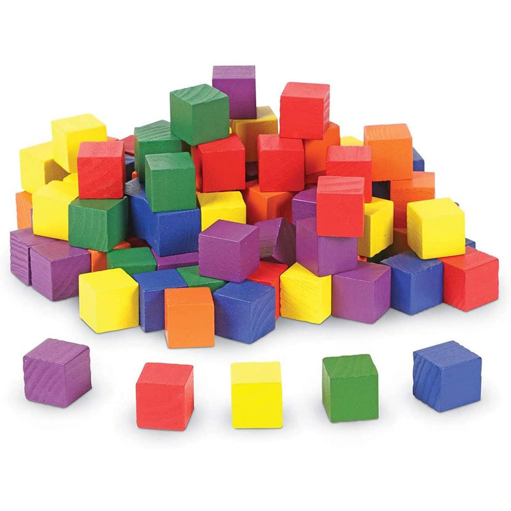 Pile of colorful 1cm natural pine wood cubes for crafts and DIY projects, with some cubes scattered in front.