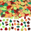 Assorted glitter and foam fall leaf stickers in various colors and shapes, scattered on a white background.