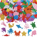 Assortment of glitter sea animal foam stickers including sharks, dolphins, turtles, crabs, octopuses, and starfish on a white background.