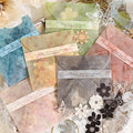 Assortment of decorative paper envelopes and cutouts featuring floral and butterfly designs, arranged in a flat lay.
