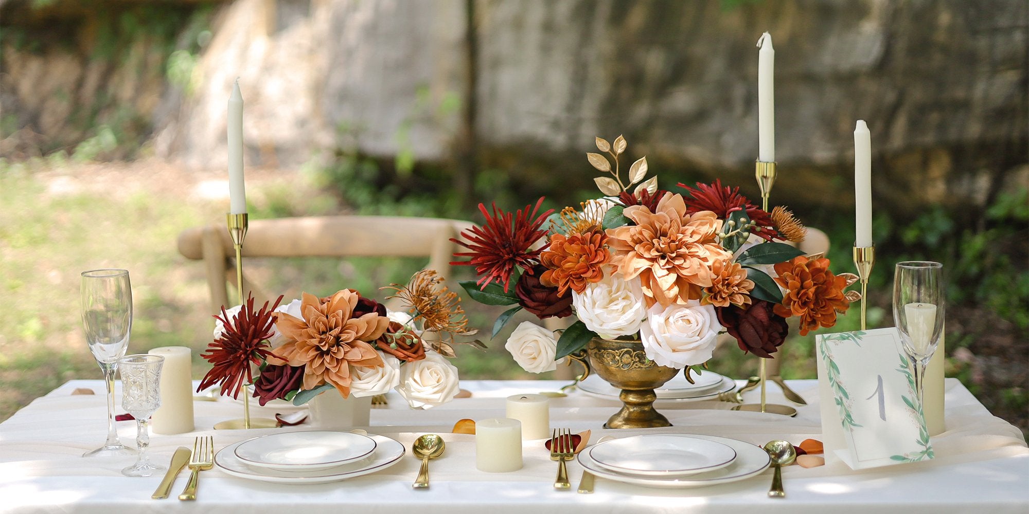 Wedding table setting with floral arrangements, candles, and place settings.
