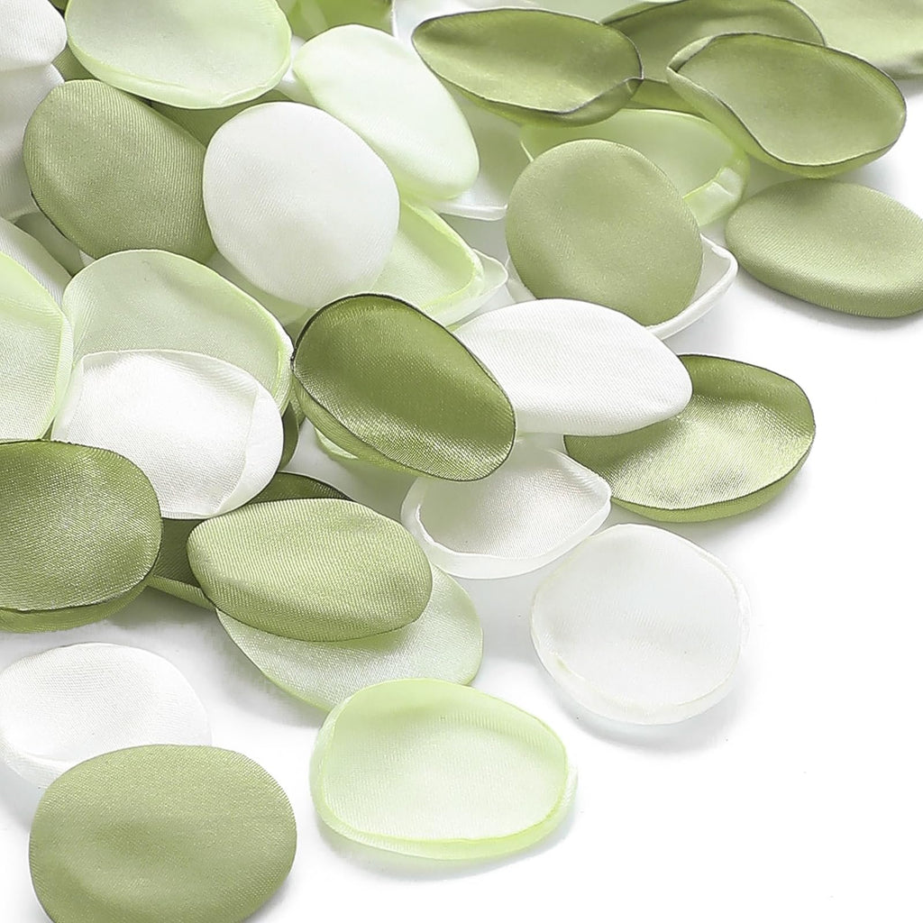 Pile of faux silk rose petals in pale green and white, scattered on a white background.
