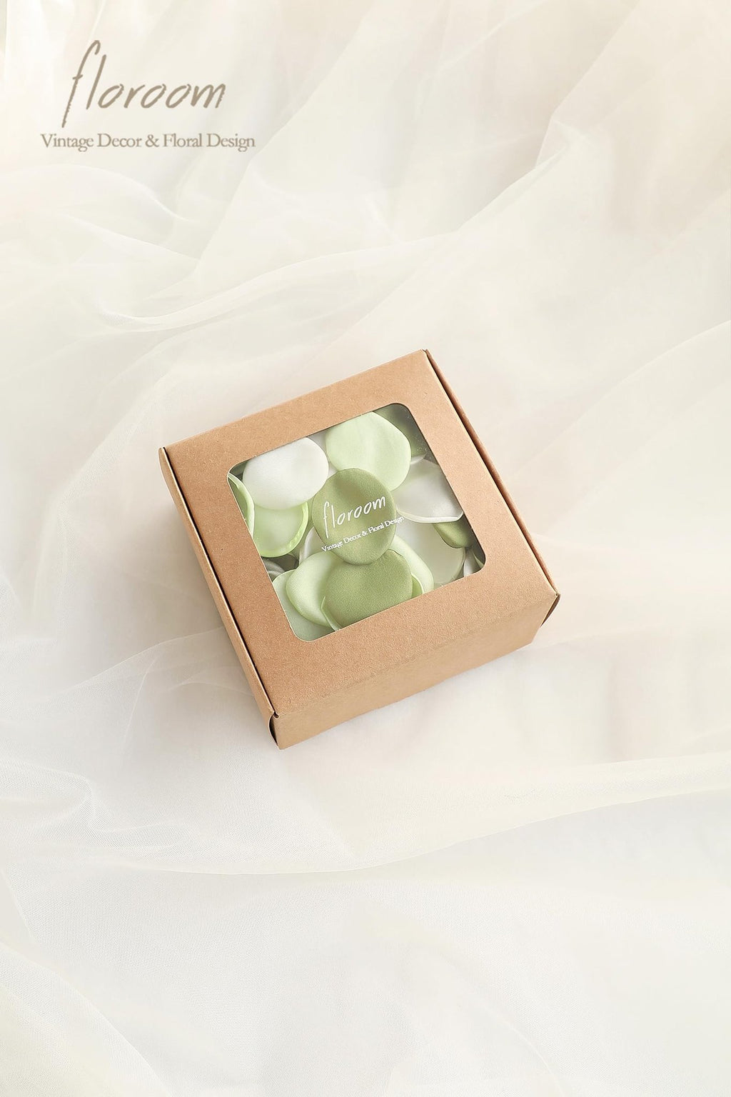 Box of faux silk rose petals in green and white, with brand text on the lid.