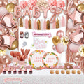 Baby girl shower party decorations and tableware set with balloons, banner, plates, cups, and cupcakes.