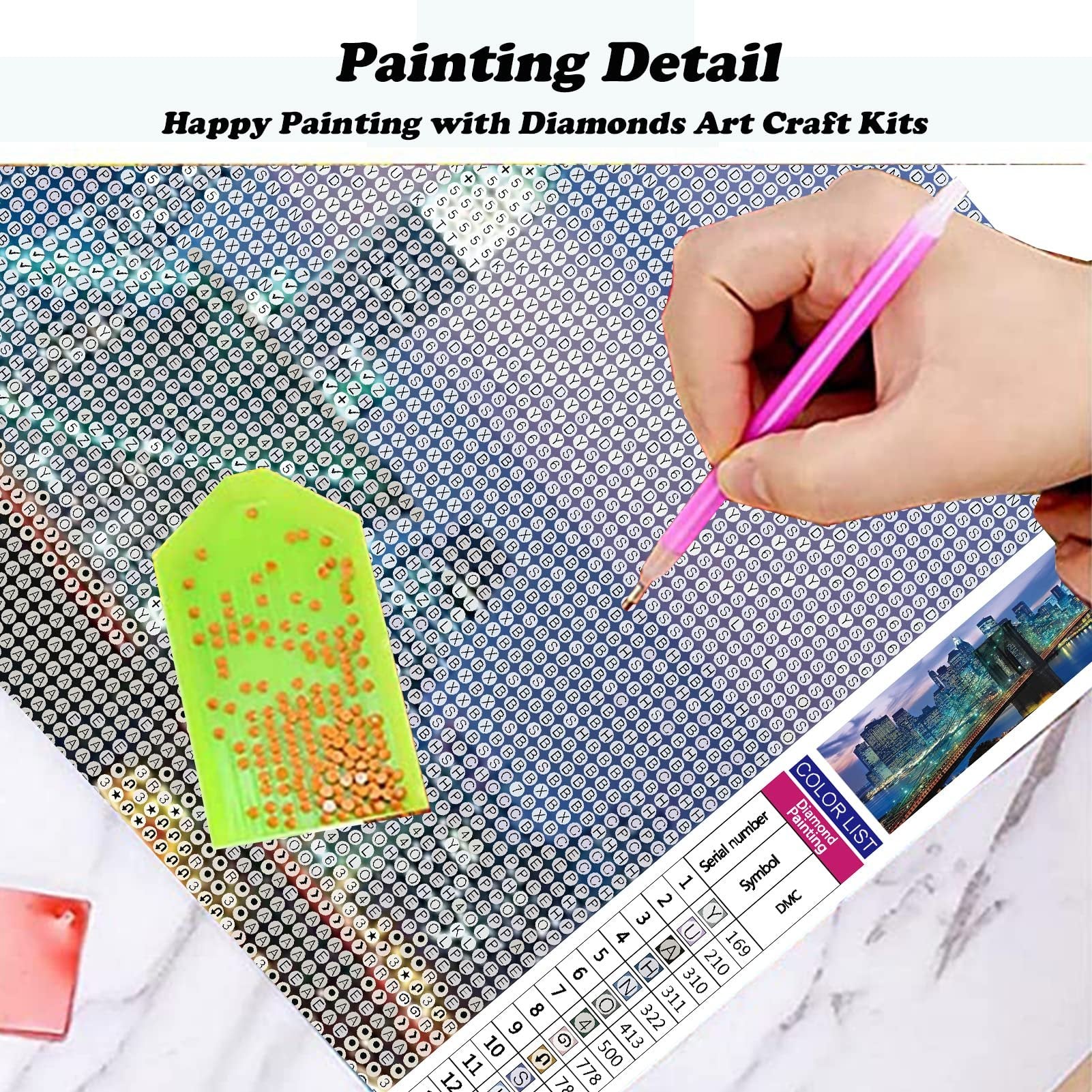 Diamond painting kit in progress, showing a hand holding a pink drill pen over a canvas with symbols and a green tray of drills.