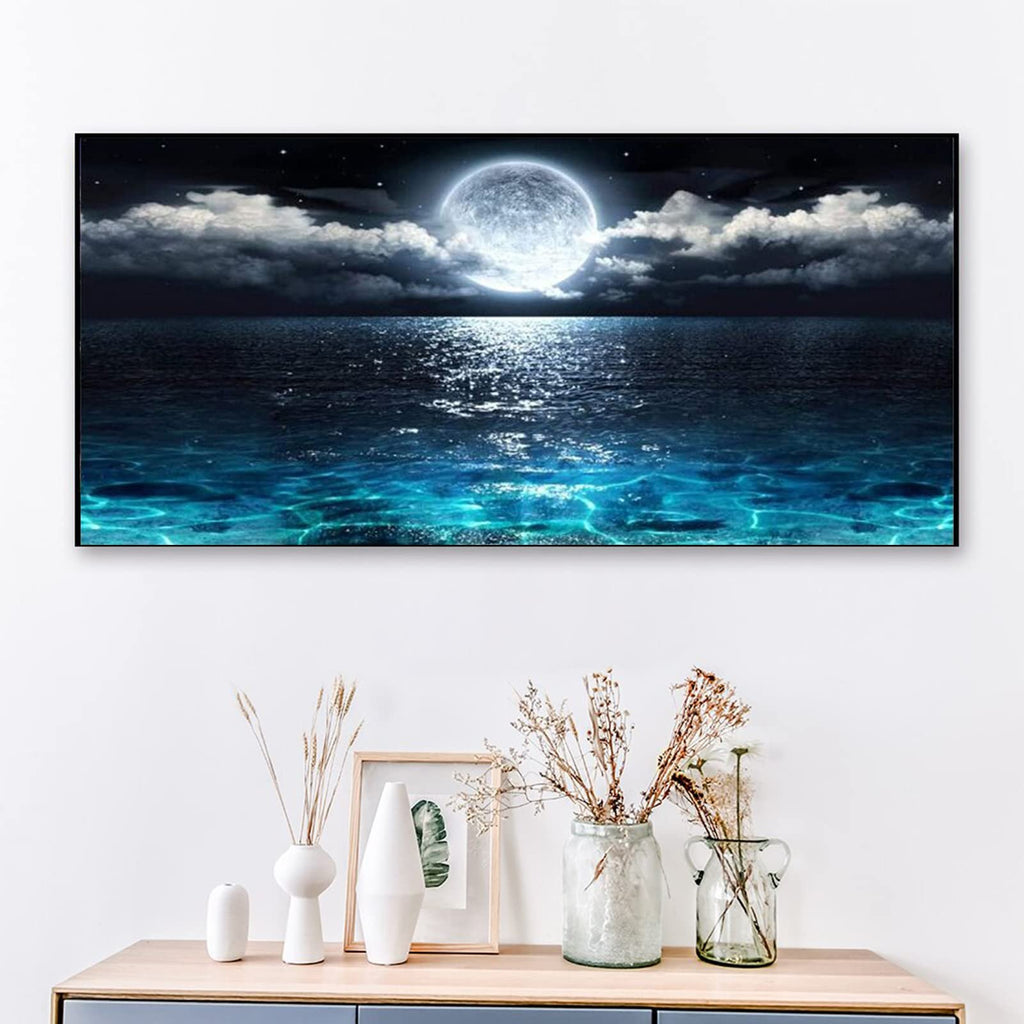 Diamond painting kit showing a full moon over a dark ocean with sparkling water, displayed on a wall above decorative vases.