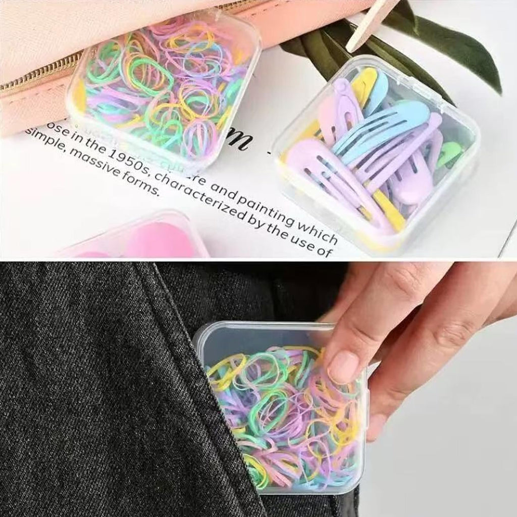 Clear plastic organizer boxes filled with colorful hair elastics and pastel hair clips, one box being placed into a pocket.