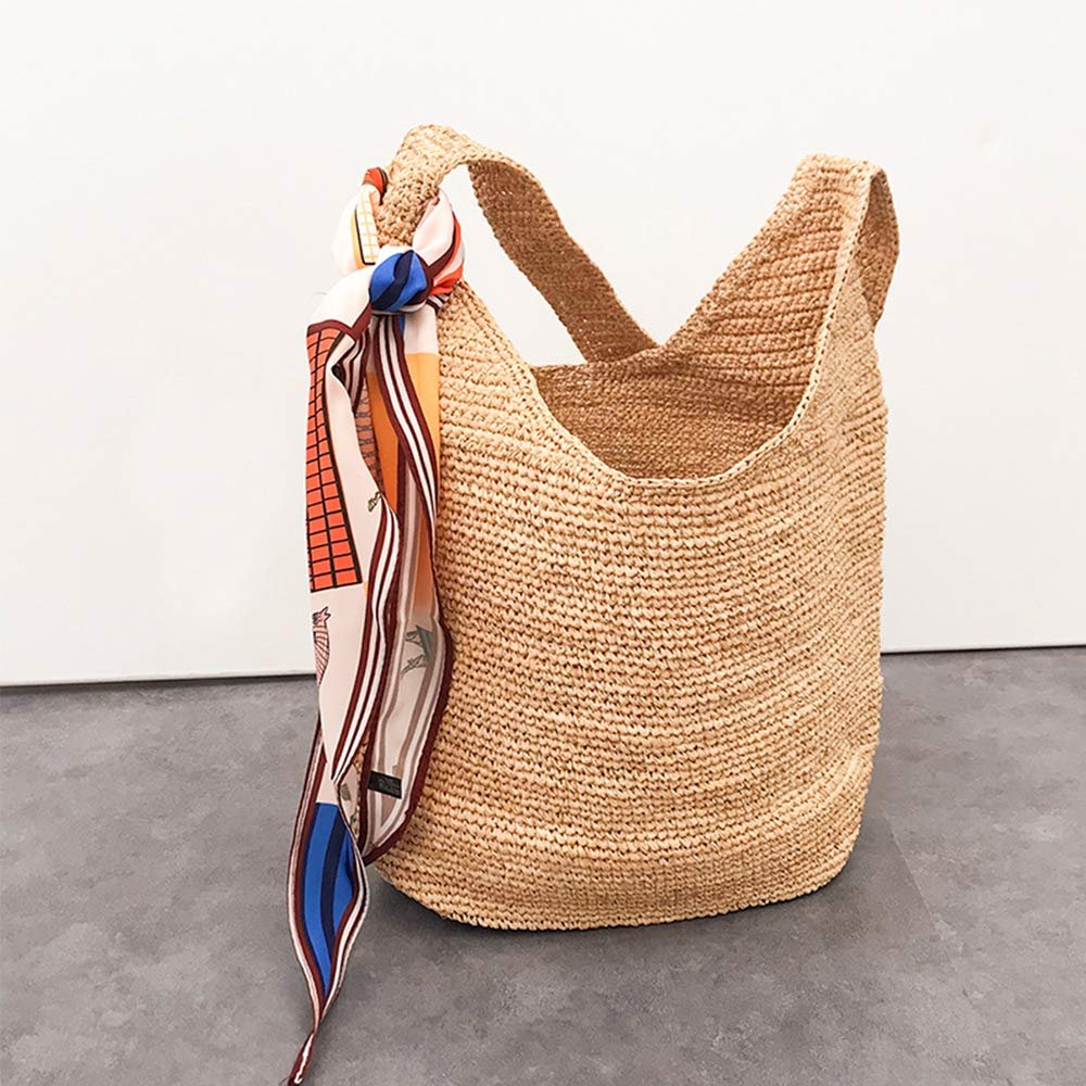 Woven straw tote bag with a colorful patterned scarf tied to the handle, shown from the front.