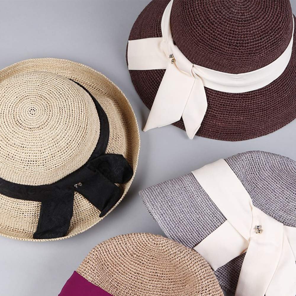 Four straw hats with decorative ribbons and bows, arranged on a neutral background.