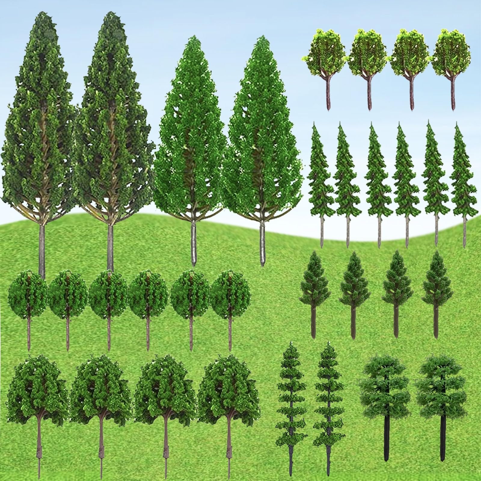Collection of 32 miniature model trees in various styles and sizes, arranged on a green grassy background with a blue sky.