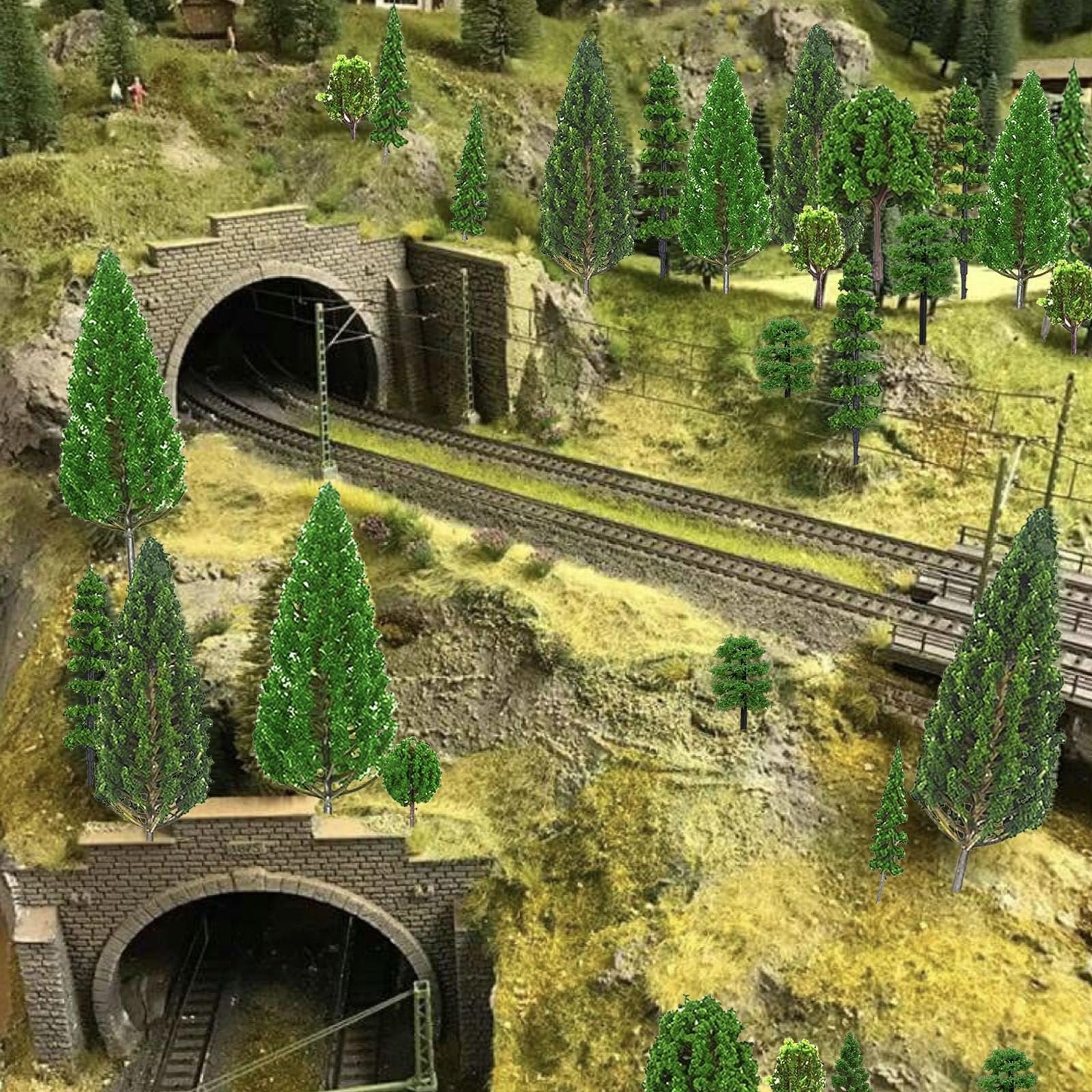Model train tunnel entrance with miniature trees and tracks on a diorama landscape