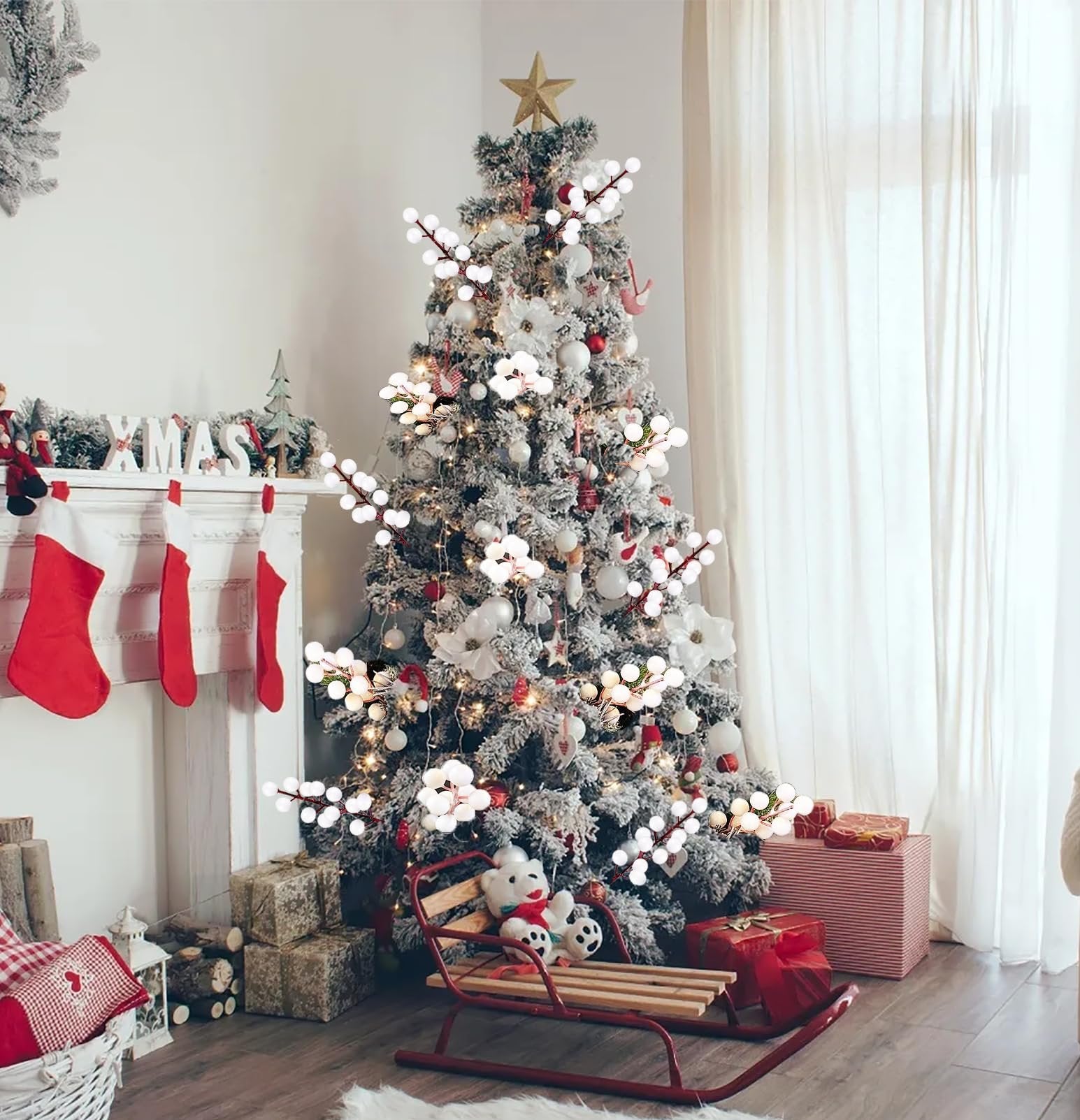 Flocked Christmas tree decorated with white berry stems and ornaments, with a fireplace and stockings to the left.