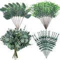 Four arrangements of artificial eucalyptus stems with varying leaf shapes and colors on a white background.