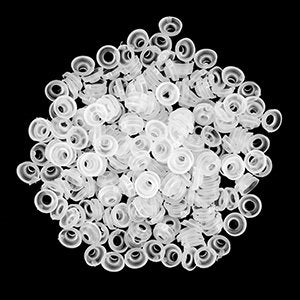 Pile of 320 clear plastic safety washers for craft eyes on black background