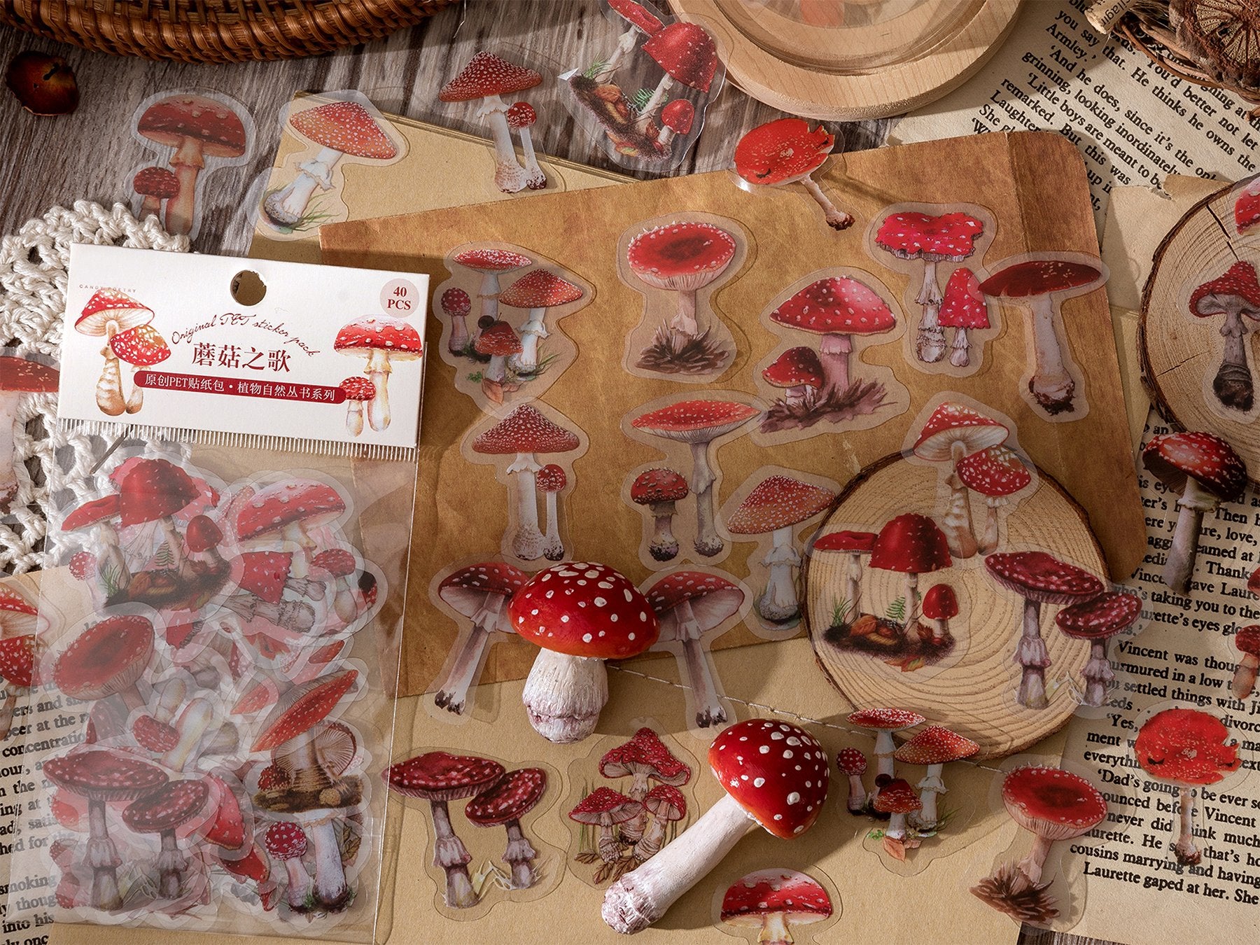 Assortment of clear PET mushroom stickers scattered on a textured surface with a partial view of a book and wooden slices.