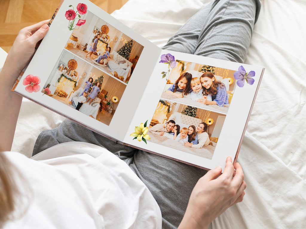Open photo album with family pictures and decorative floral stickers on pages