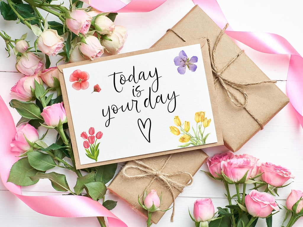 Card with 'Today is your day' text surrounded by pink roses, yellow tulips, and a purple flower.
