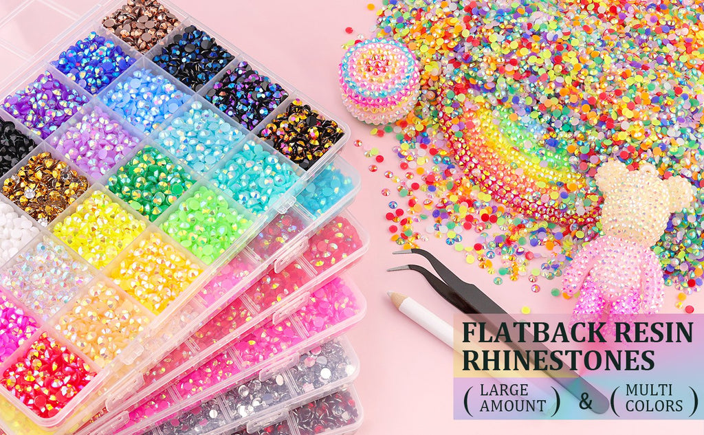 Assortment of colorful flatback resin rhinestones in a divided organizer box with tweezers and a pickup pen.