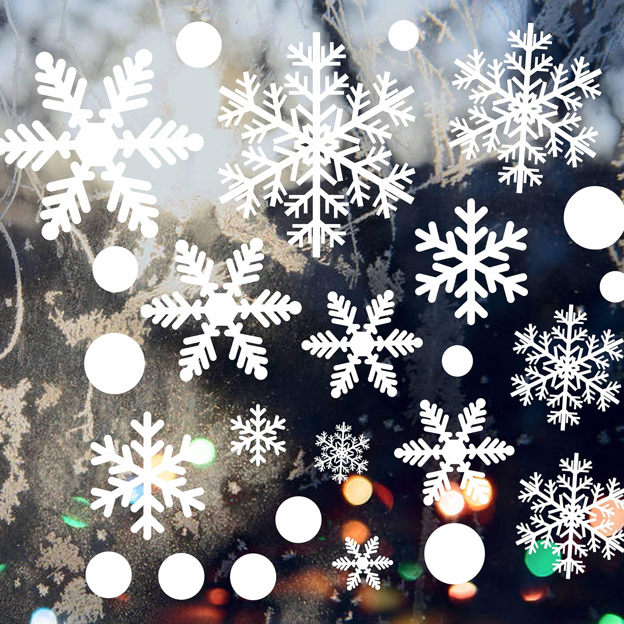 White snowflake and circle window decals on a frosted window with bokeh lights