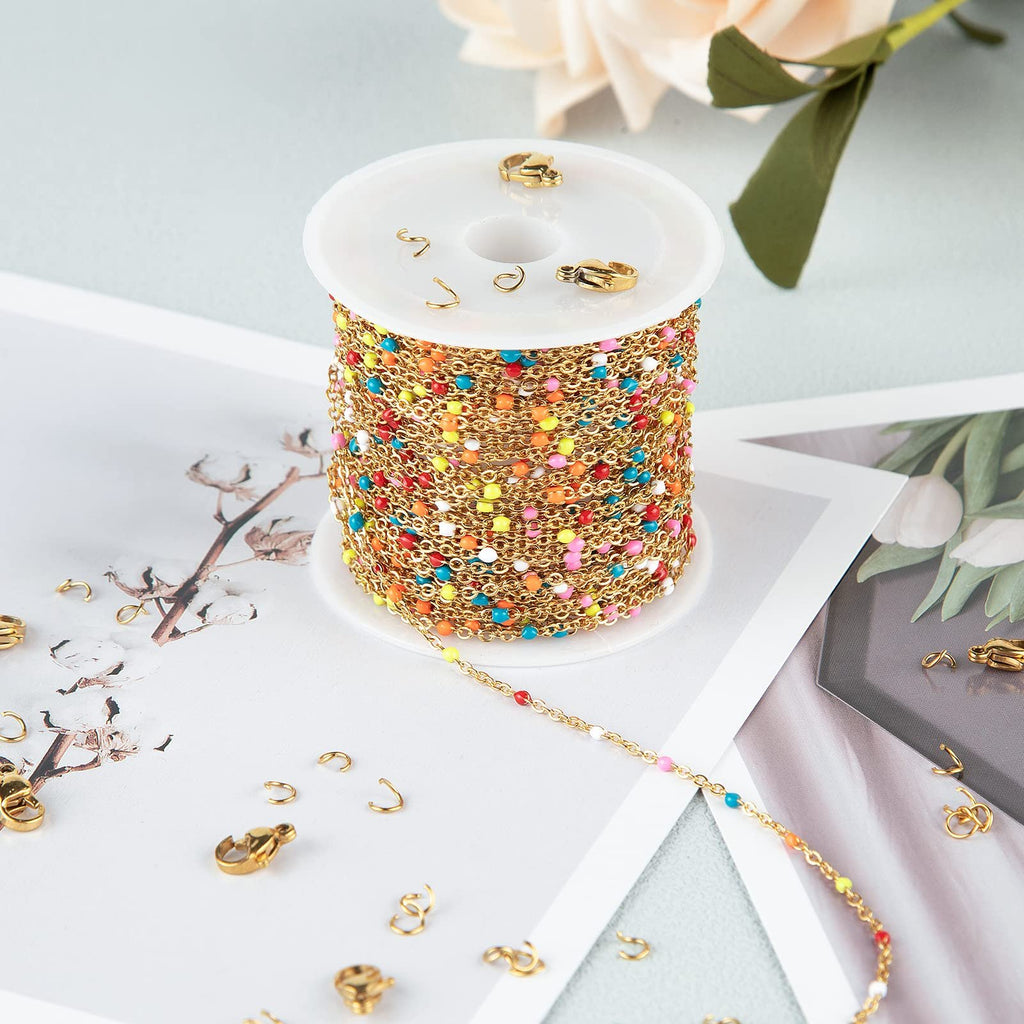 Spool of gold-plated stainless steel beaded jewelry chain with colorful enamel beads, surrounded by lobster clasps and jump rings.