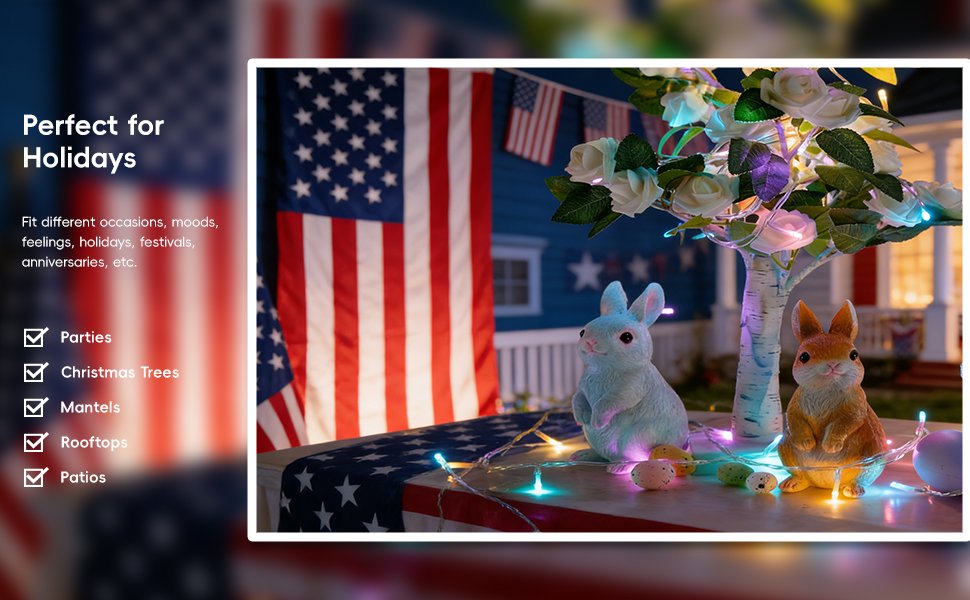 Easter decorations with string lights, featuring two bunny figurines, eggs, and American flags, set against a house backdrop.