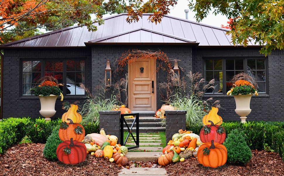 Stacked hand-painted pumpkins and gourds decorating a house entrance for fall outdoor decor