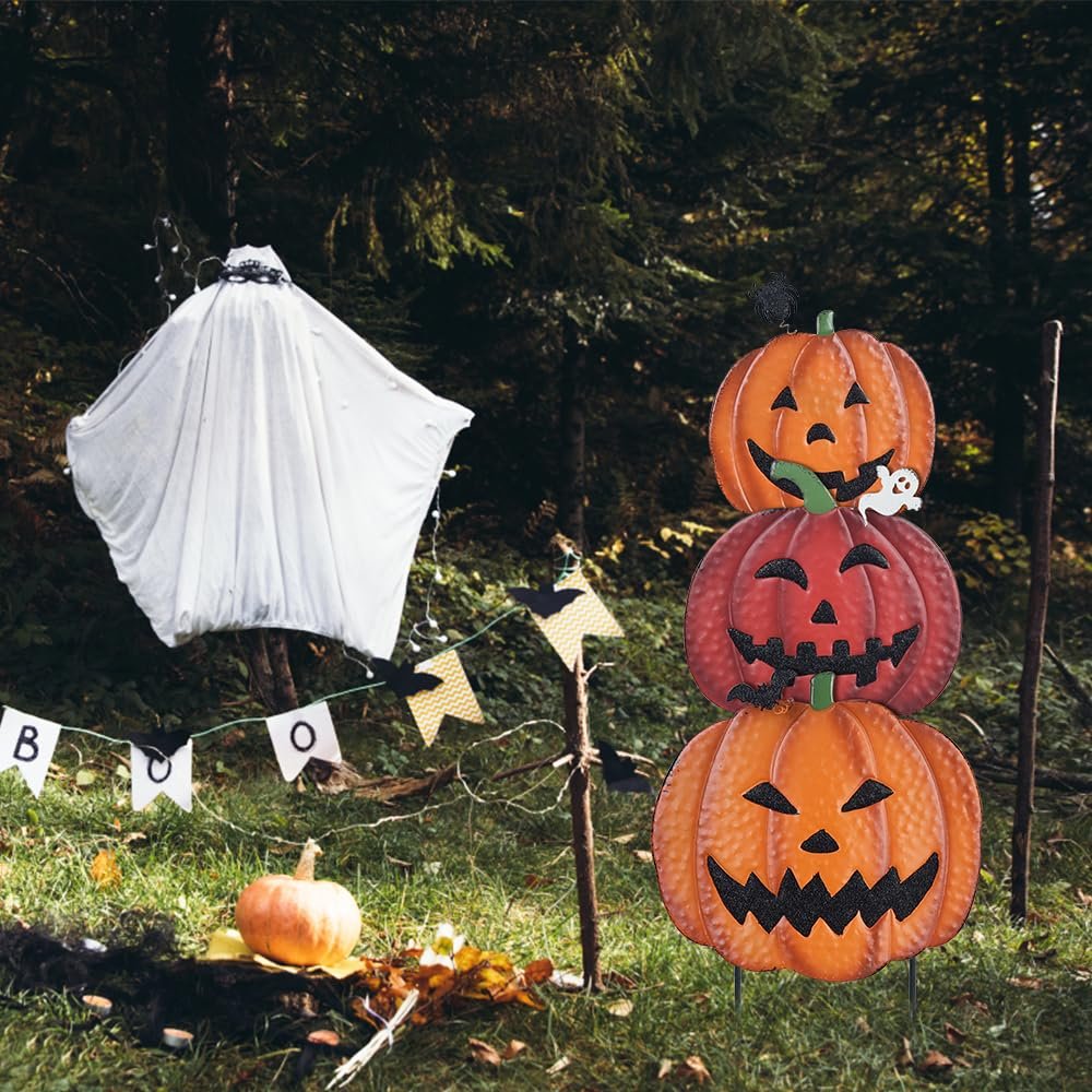 Stackable metal pumpkin garden stake with Halloween decorations in a wooded yard