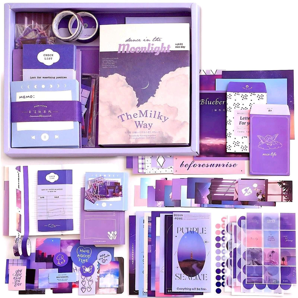Aesthetic scrapbook kit contents laid out, including notebooks, stickers, envelopes, and tape in purple and pink tones.