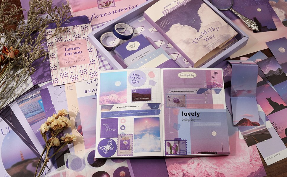 Aesthetic scrapbook kit contents laid out, featuring a notebook, stickers, washi tape, and decorative paper in shades of purple and pink.