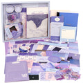 Aesthetic scrapbook kit contents including notebooks, stickers, washi tape, and decorative paper in shades of purple and blue.