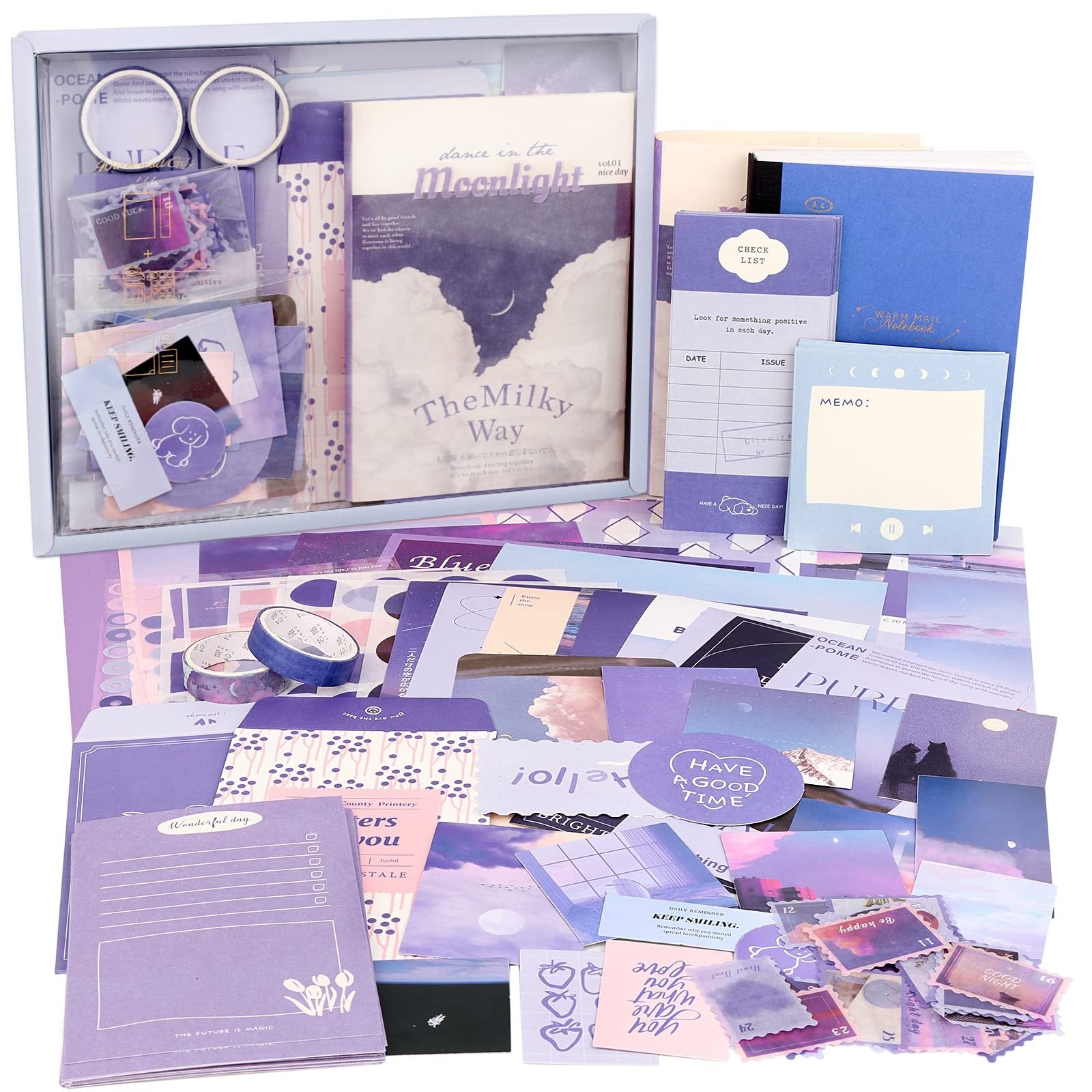 Aesthetic scrapbook kit contents including notebooks, stickers, washi tape, and decorative paper in shades of purple and blue.