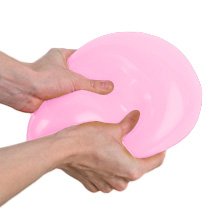 Hands holding a large, uninflated pastel pink latex balloon against a white background.