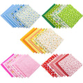 Five stacks of patterned cotton fabric squares in blue, green, yellow, pink, and red on a white background.