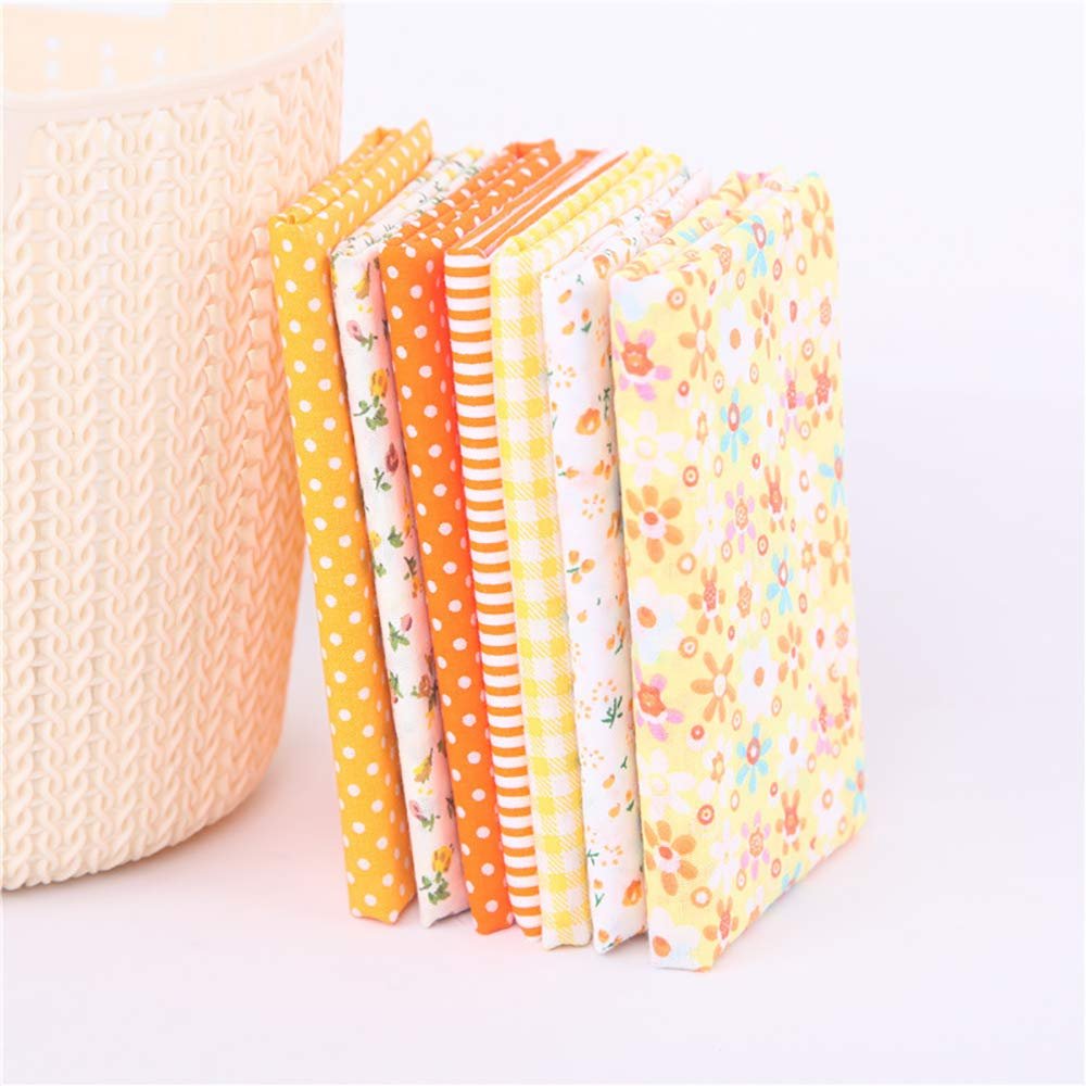 Stack of colorful patterned fabric squares in yellow, orange, and white, leaning against a textured basket.