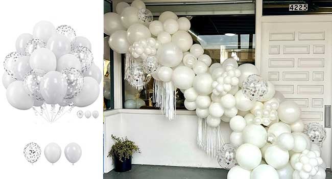 White and silver balloon garland with confetti balloons and white tassels, displayed on a doorway.