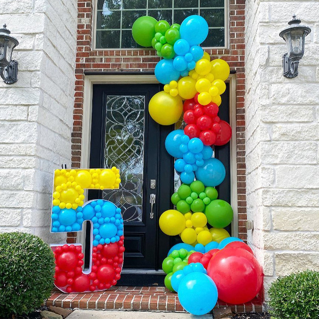 Balloon number 5 and balloon garland decorating a front door for a party