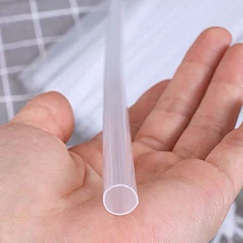Hand holding a clear plastic balloon stick, showing the hollow end and ribbed texture. Other sticks are blurred in the background.