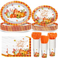 Thanksgiving pumpkin tableware set with plates, cups, napkins, and cutlery, featuring orange buffalo plaid and fall leaves.