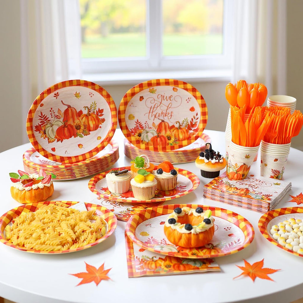Thanksgiving tableware set with pumpkins and buffalo plaid pattern, including plates, cups, napkins, and cutlery.