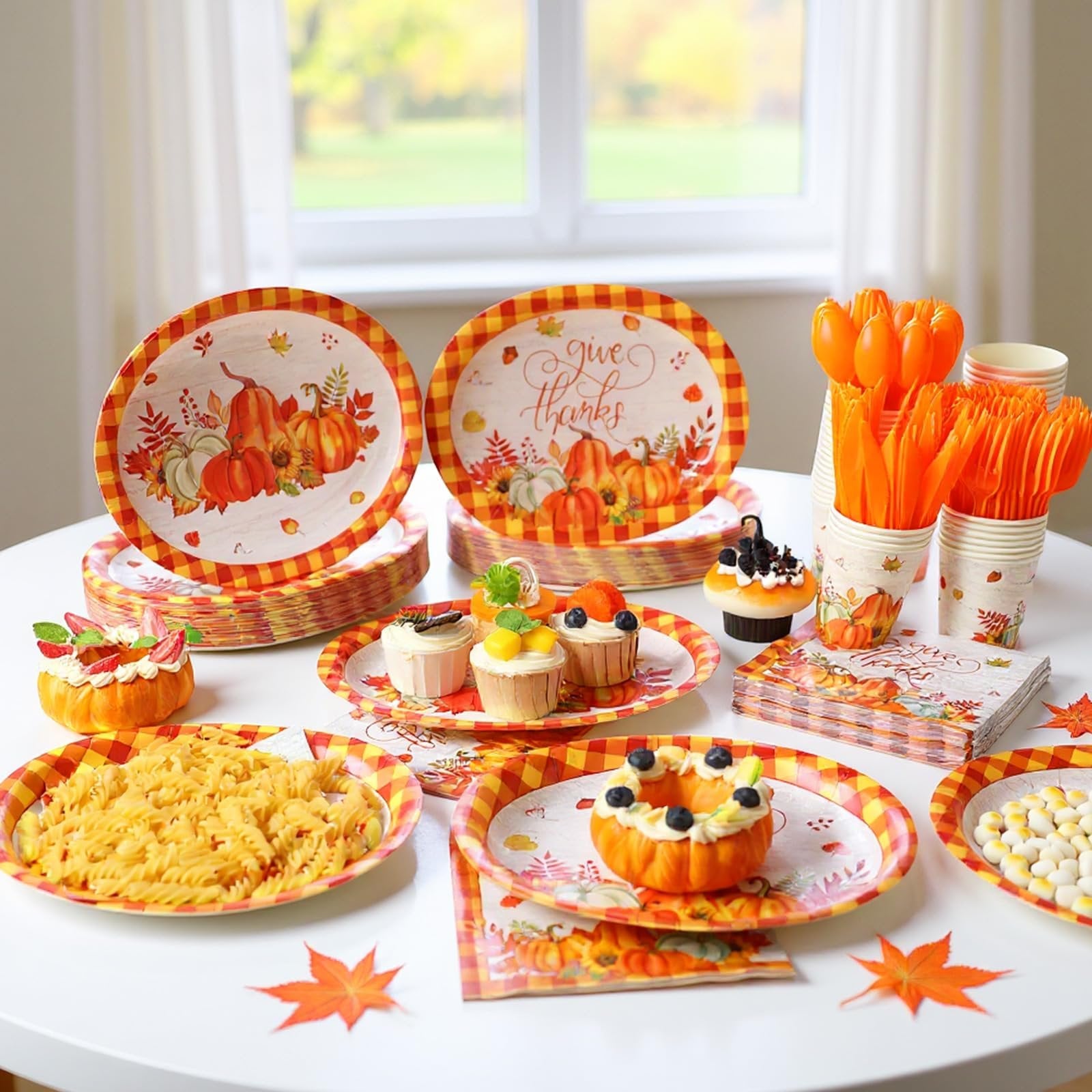 Thanksgiving tableware set with pumpkins and buffalo plaid pattern, including plates, cups, napkins, and cutlery.