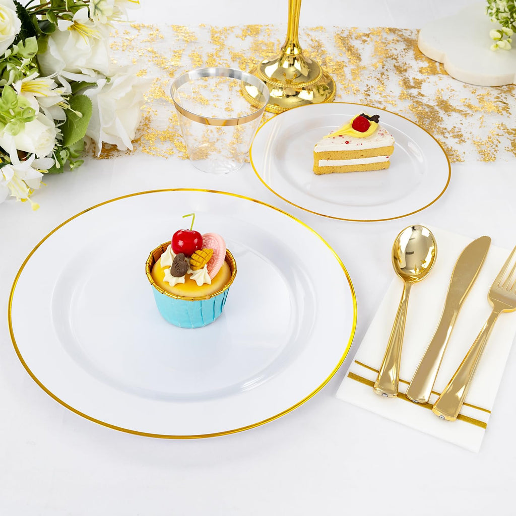 White disposable dinner plate with gold rim, topped with a cupcake, next to a slice of cake on another plate.
