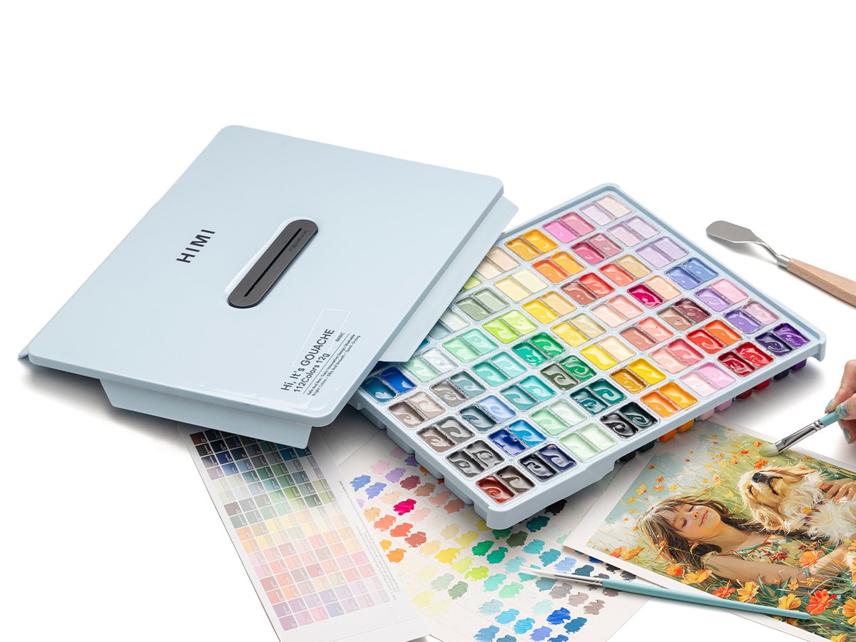 Open light blue case filled with 112 colors of jelly gouache paint, with brushes and color swatches.