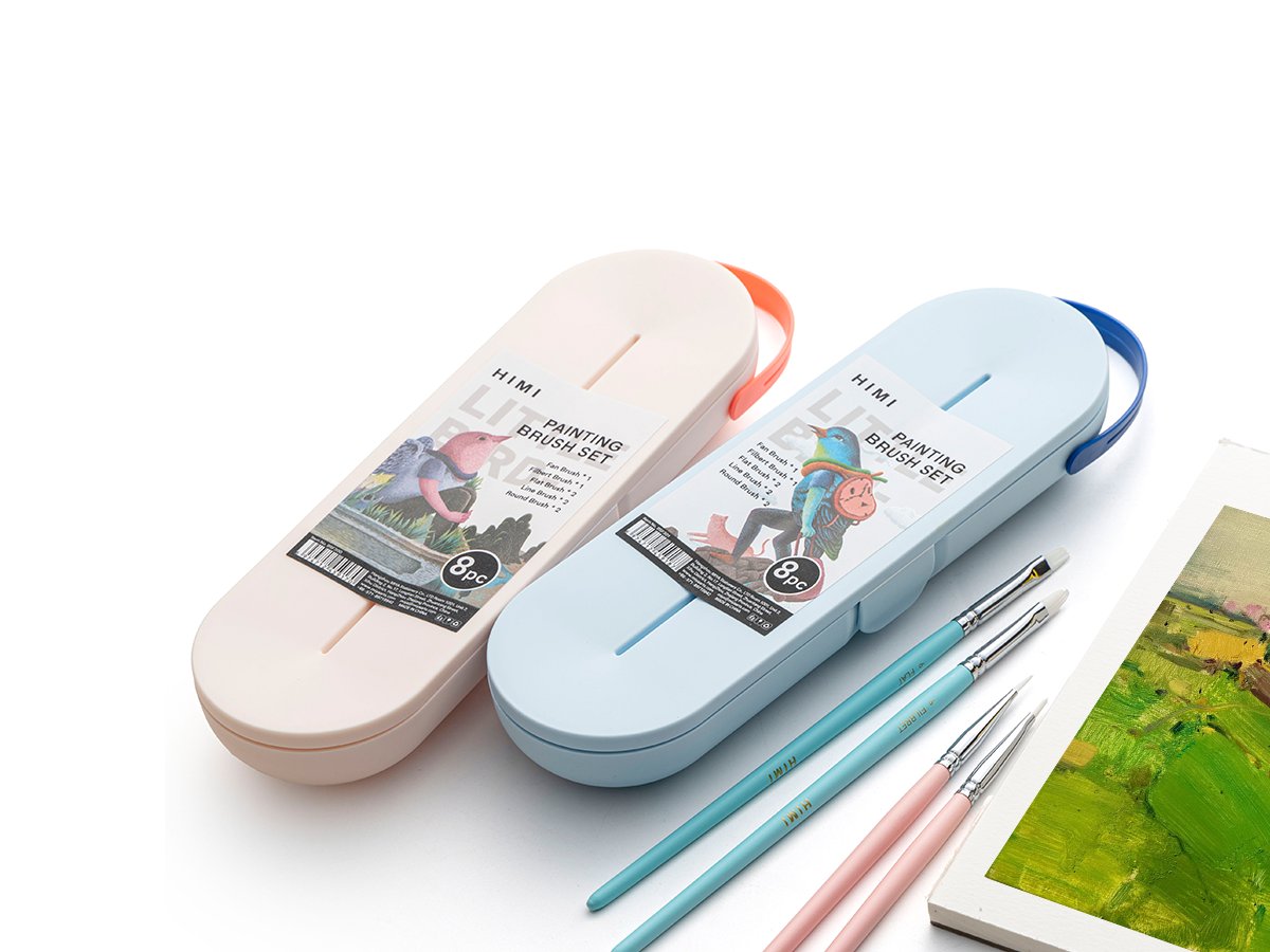 Two portable painting brush sets, one cream and one light blue, with brushes laid out in front of a canvas.