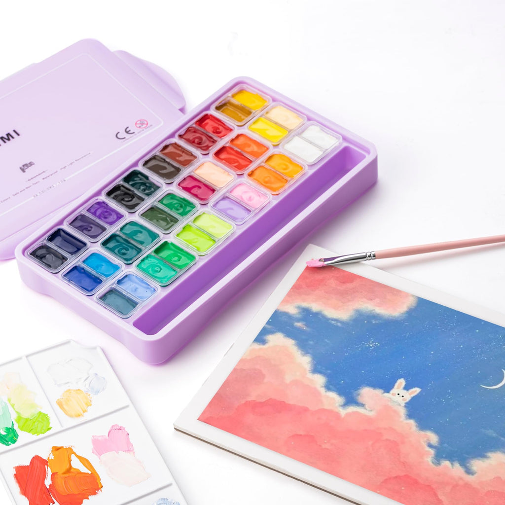 Open purple paint case with 36 colors of gouache paint, a palette with mixed paints, and a paintbrush on a drawing of a sky with clouds and a bunny.