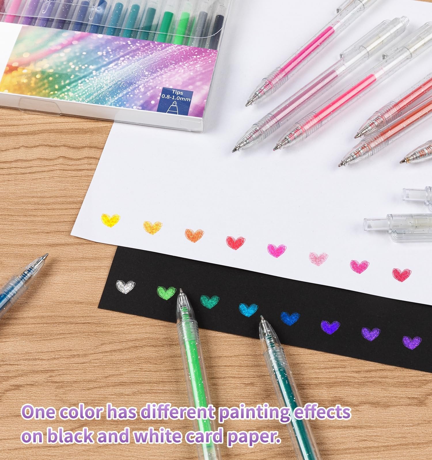 Metallic glitter gel pens with various colors drawn as hearts on white and black paper.