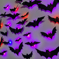 Assorted sizes of black 3D bat wall decor with colorful LED lights illuminating from within, arranged on a light-colored wall.
