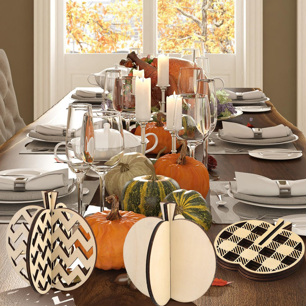 Fall craft kit with wooden pumpkin cutouts and pumpkins arranged on a Thanksgiving dinner table